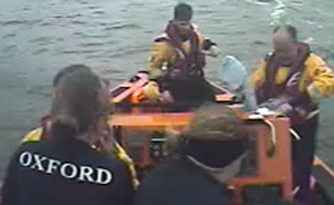 Oxford rowers take refuge on the Chiswick lifeboat, above