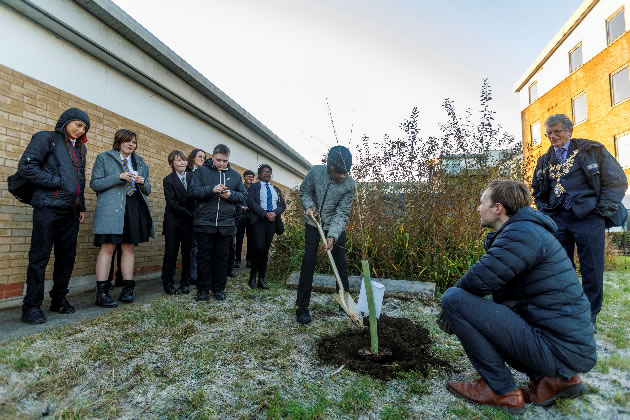 Students at Southfields Academy help with the planting 