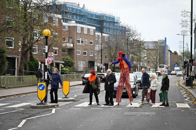 Maystar Residents’ Association committee members, including Debbie Golt (left) and Michael Gannon, MRA Co-Chair (middle) on the crossing with stilt-walker Ella the Great