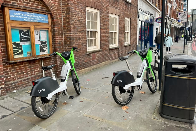 Hire bikes owned by Lime left blocking the pavement 