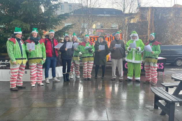 The group sang Christmas Carols with specially adapted lyrics 