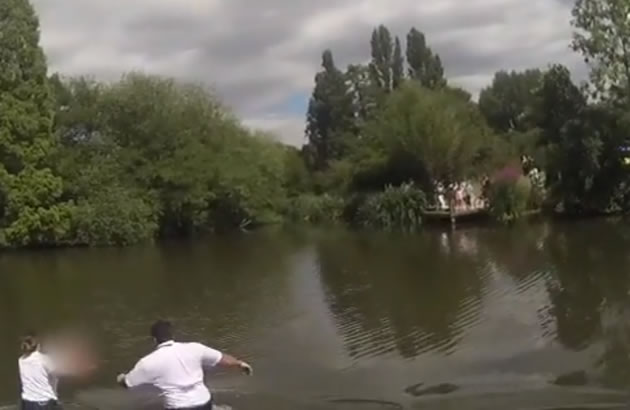 PC Amy Bale and PC Red Haddouch wade into the water